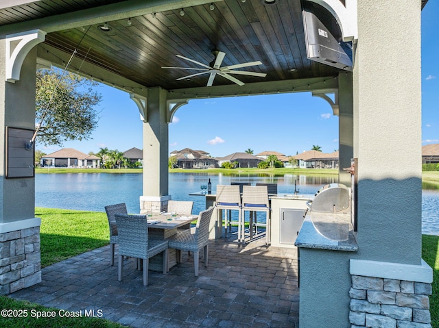 3882 Durksly Dr, Melbourne, FL 32940 - view of patio / terrace with outdoor dining space, a water view, exterior kitchen, and a ceiling fan