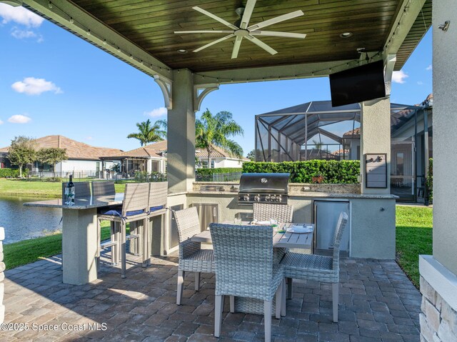 3882 Durksly Dr, Melbourne, FL 32940 - view of patio featuring outdoor dry bar, area for grilling, ceiling fan, exterior kitchen, and a lanai