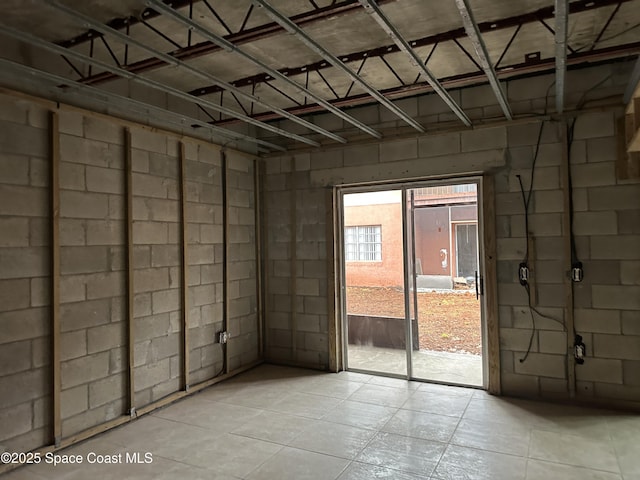 interior space with concrete block wall