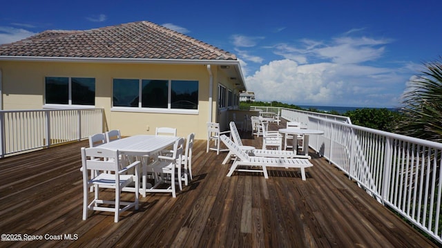 deck with outdoor dining area