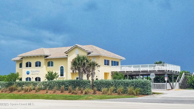 view of front of home featuring a tile roof and stucco siding