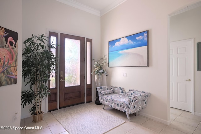 entrance foyer with baseboards, ornamental molding, and tile patterned floors