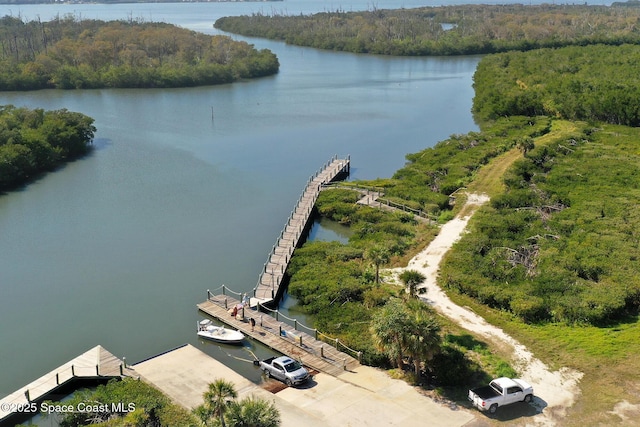 aerial view with a water view and a forest view