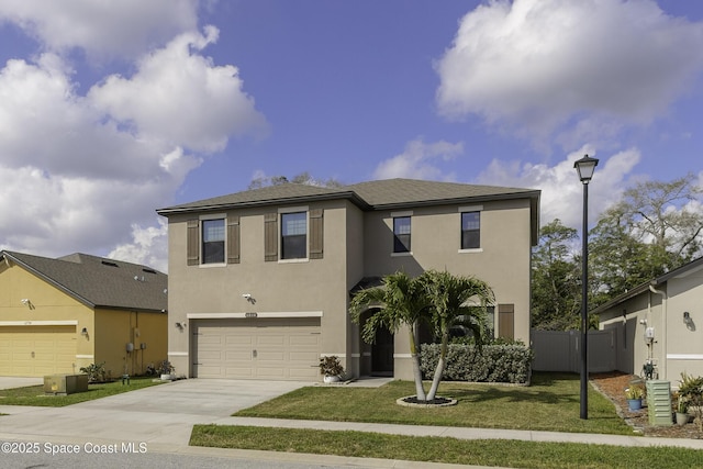 view of front of house with a garage, fence, concrete driveway, stucco siding, and a front yard