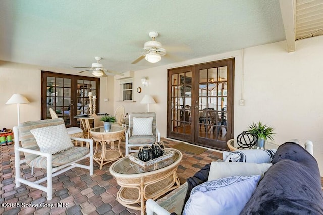 interior space with ceiling fan, beamed ceiling, and french doors