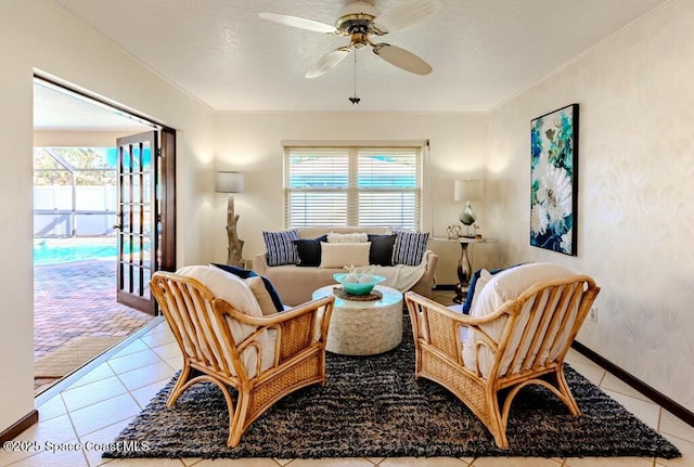 living area with a ceiling fan, a wealth of natural light, and tile patterned floors