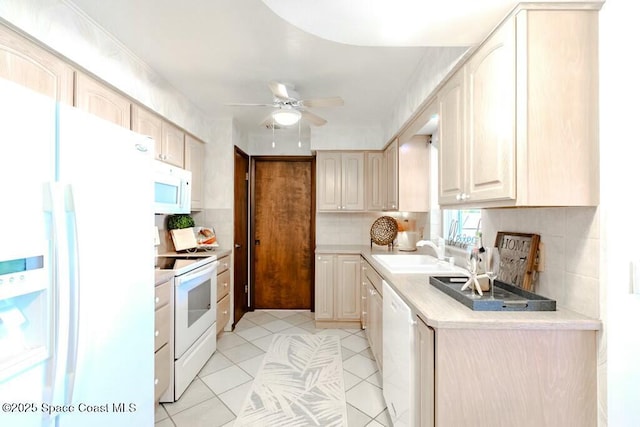 kitchen featuring light countertops, decorative backsplash, a sink, ceiling fan, and white appliances