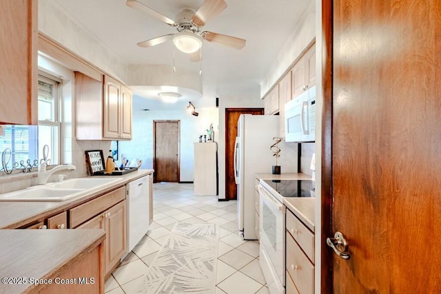 kitchen featuring light tile patterned floors, light countertops, ceiling fan, a sink, and white appliances