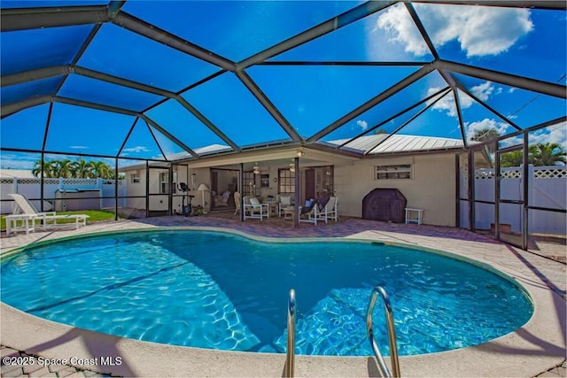 view of swimming pool featuring a fenced in pool, glass enclosure, a patio area, and fence