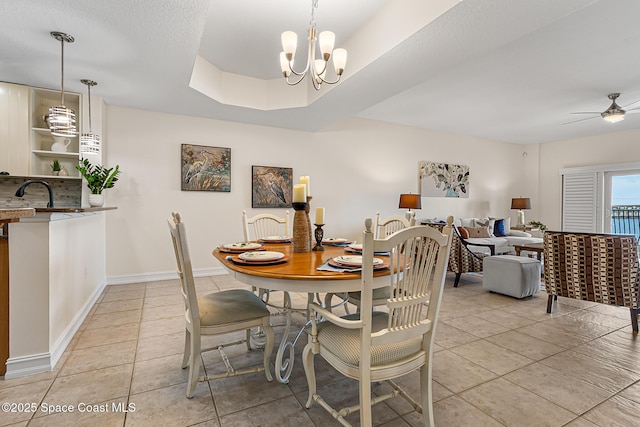 29 Riverside Dr Unit 402, Cocoa, FL 32922 - dining area with light tile patterned floors, a ceiling fan, and a chandelier