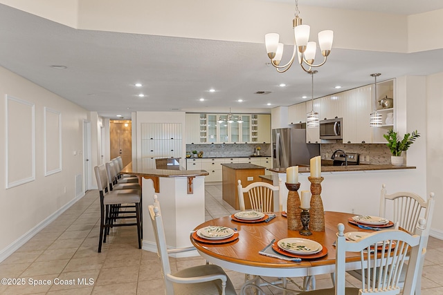 29 Riverside Dr Unit 402, Cocoa, FL 32922 - dining space with light tile patterned floors, a chandelier, and recessed lighting