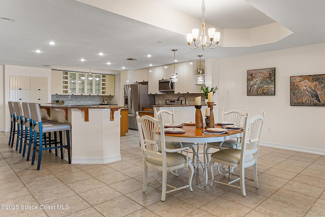 29 Riverside Dr Unit 402, Cocoa, FL 32922 - dining room featuring a chandelier, light tile patterned floors, and recessed lighting