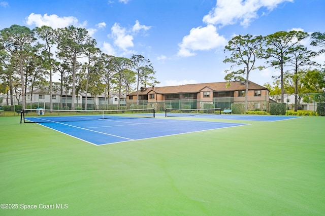 view of sport court featuring fence