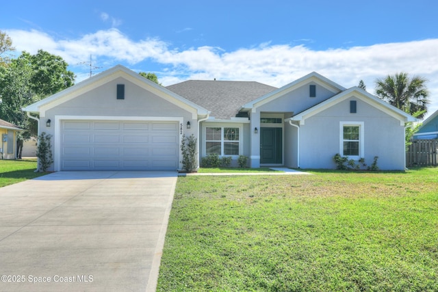 view of front facade with a garage, concrete driveway, a front yard, and stucco siding