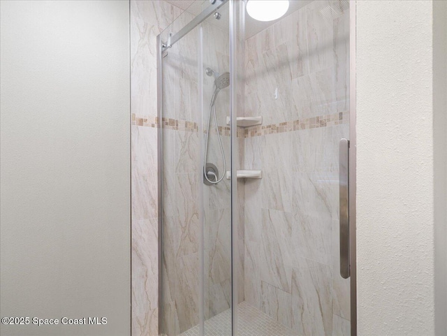 bathroom with a marble finish shower