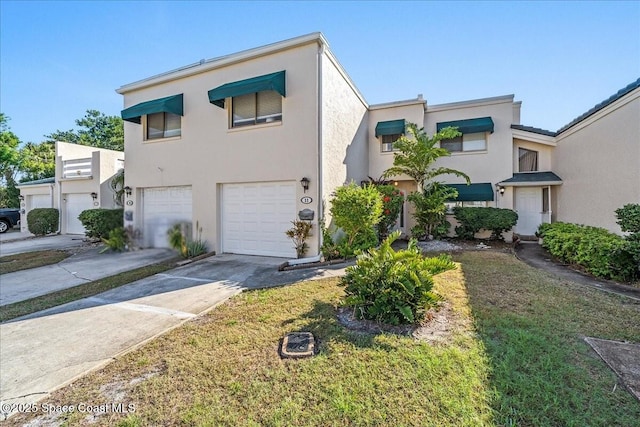 view of front of home featuring a garage, driveway, and stucco siding