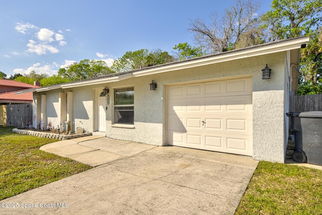 ranch-style house featuring concrete driveway, a front lawn, an attached garage, and stucco siding