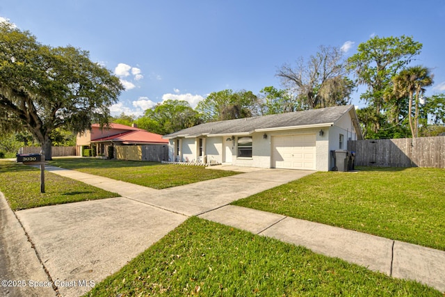 ranch-style house with driveway, an attached garage, fence, and a front lawn