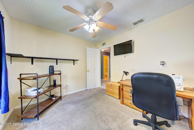 office with carpet floors, visible vents, and a textured ceiling