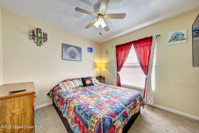 carpeted bedroom featuring a ceiling fan, a textured ceiling, and baseboards