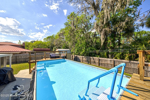 view of pool featuring a fenced in pool, a fenced backyard, and a wooden deck