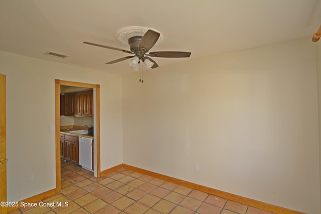 spare room featuring baseboards, visible vents, ceiling fan, and light tile patterned flooring