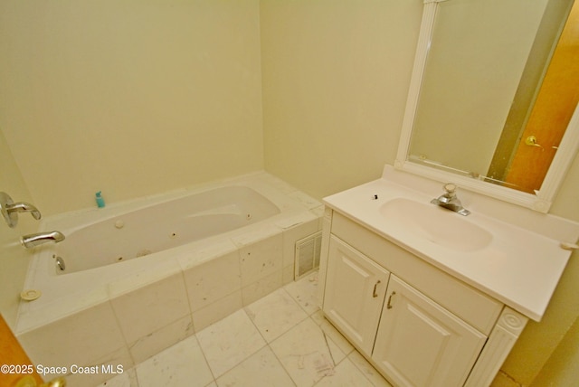 full bath featuring visible vents, a jetted tub, and vanity