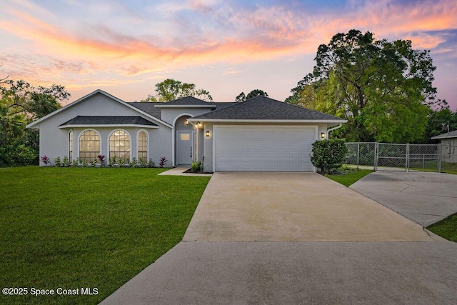 view of front of home with roof with shingles, concrete driveway, a front yard, fence, and a garage