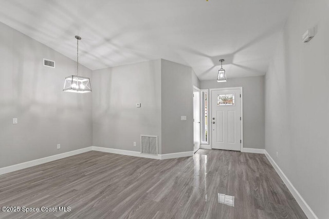 entryway featuring baseboards, visible vents, and wood finished floors