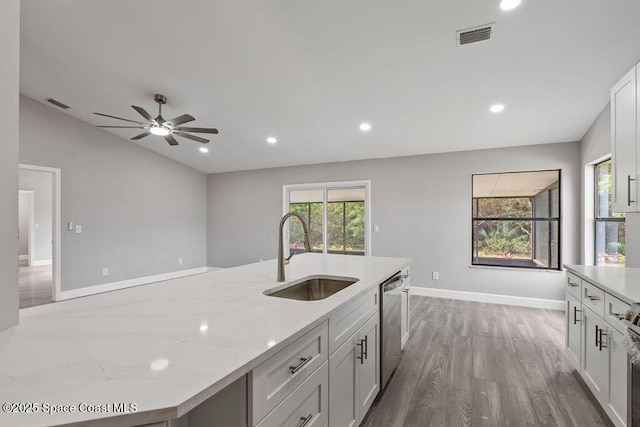 kitchen with dishwasher, plenty of natural light, a sink, and visible vents