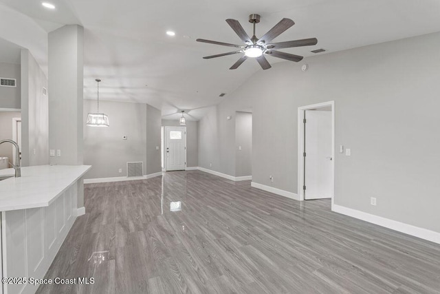 unfurnished living room featuring light wood-type flooring, baseboards, and visible vents