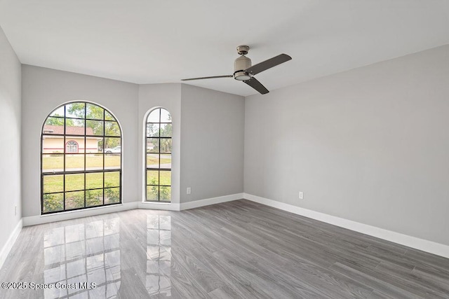 empty room featuring baseboards and a ceiling fan