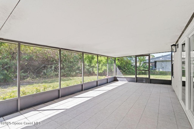 unfurnished sunroom with a wealth of natural light