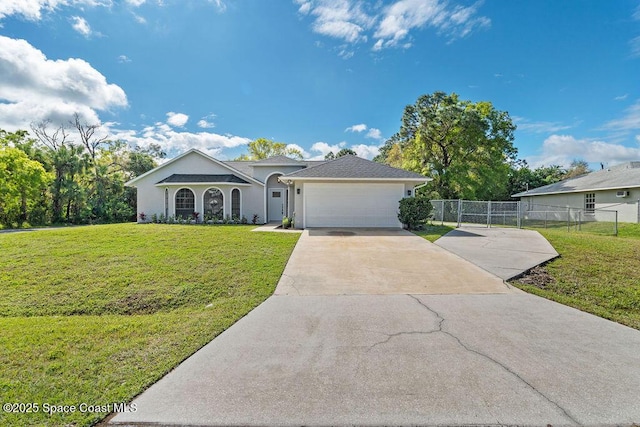 ranch-style house with a garage, a front yard, driveway, and fence