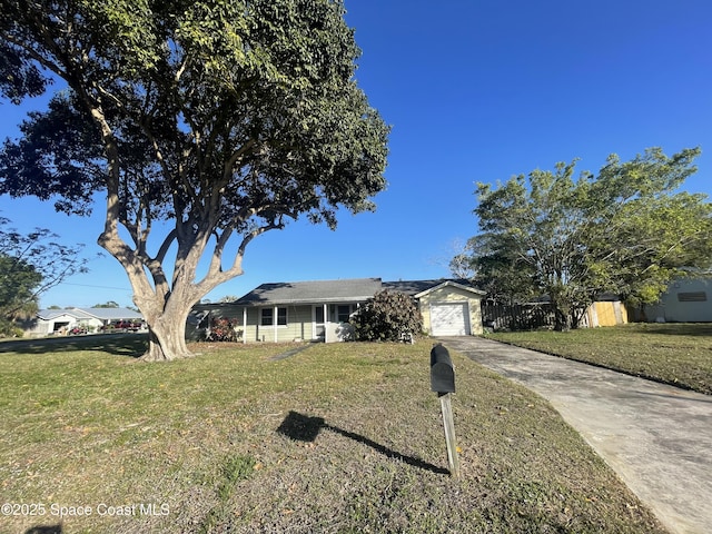 ranch-style home featuring driveway, a front yard, and fence