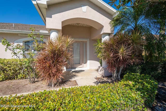 entrance to property with stucco siding