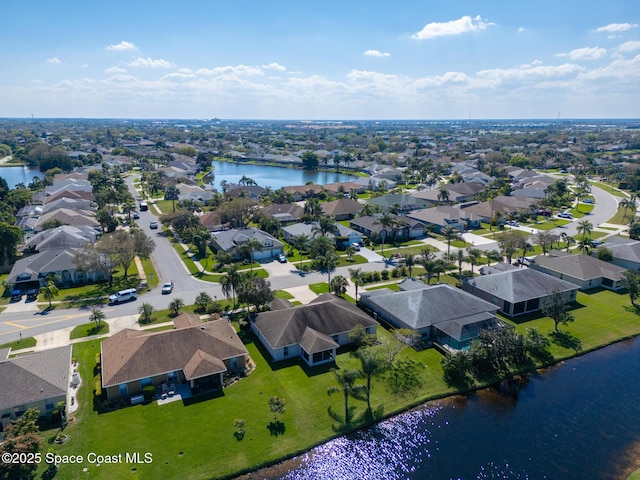 drone / aerial view featuring a water view and a residential view