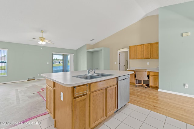 kitchen featuring light tile patterned floors, a center island with sink, light countertops, stainless steel dishwasher, and a sink