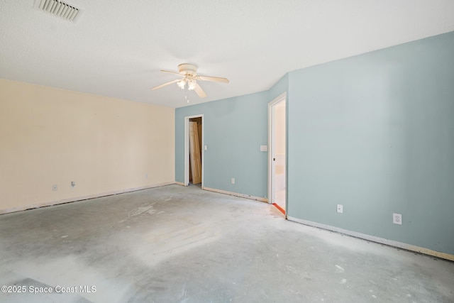 unfurnished room featuring baseboards, a ceiling fan, visible vents, and unfinished concrete floors