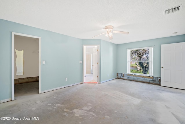 unfurnished bedroom with visible vents, a ceiling fan, a textured ceiling, concrete floors, and baseboards