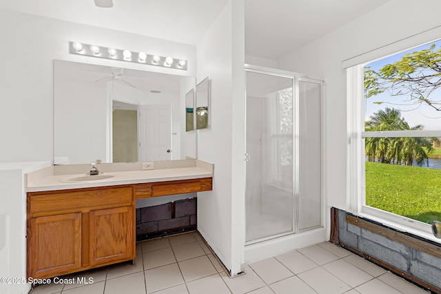 full bathroom featuring tile patterned flooring, plenty of natural light, a shower stall, and vanity