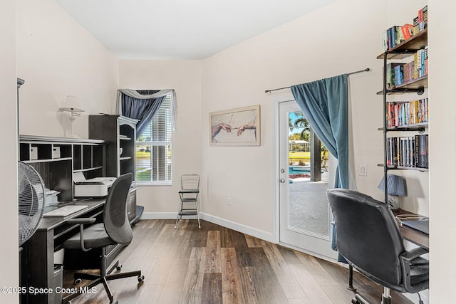 office area featuring baseboards and wood finished floors