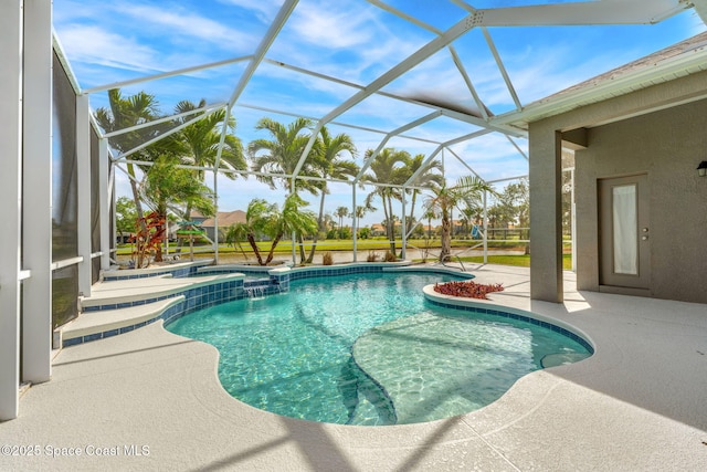 view of swimming pool with glass enclosure, a pool with connected hot tub, and a patio