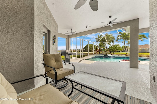 view of patio featuring a pool with connected hot tub, glass enclosure, and ceiling fan