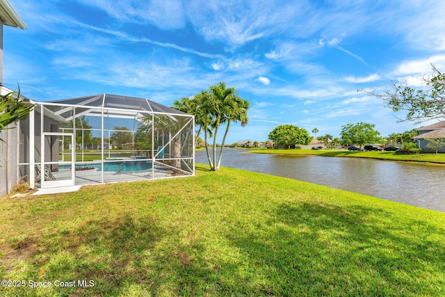 view of yard featuring a lanai, a water view, and an outdoor pool