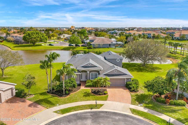 drone / aerial view with a water view and a residential view