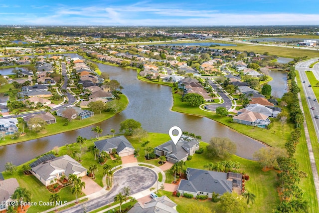 aerial view featuring a water view and a residential view