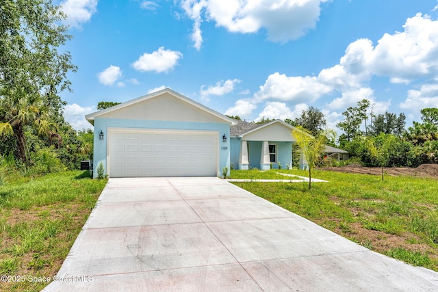 ranch-style house with concrete driveway, a front lawn, an attached garage, and stucco siding