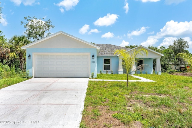 2100 Cogan Dr SE, Palm Bay, FL 32909 - ranch-style home featuring stucco siding, a front yard, concrete driveway, and an attached garage