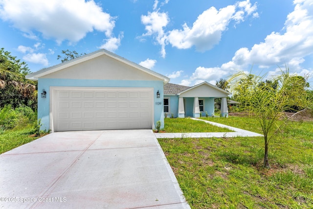 2100 Cogan Dr SE, Palm Bay, FL 32909 - ranch-style house with concrete driveway, a front lawn, a garage, and stucco siding